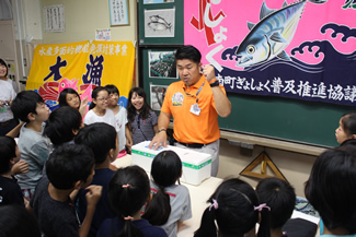 厳重に密封されたトロ箱を囲む子どもたち。